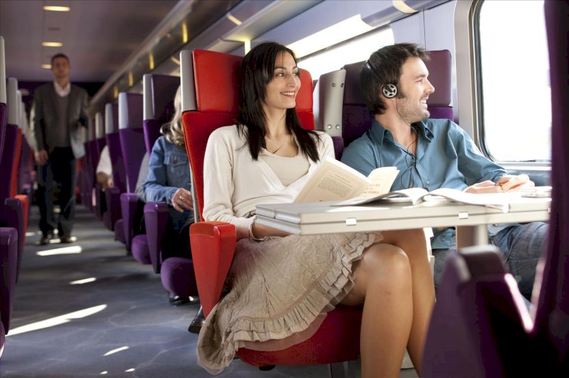 Femeie citind la o masă în tren