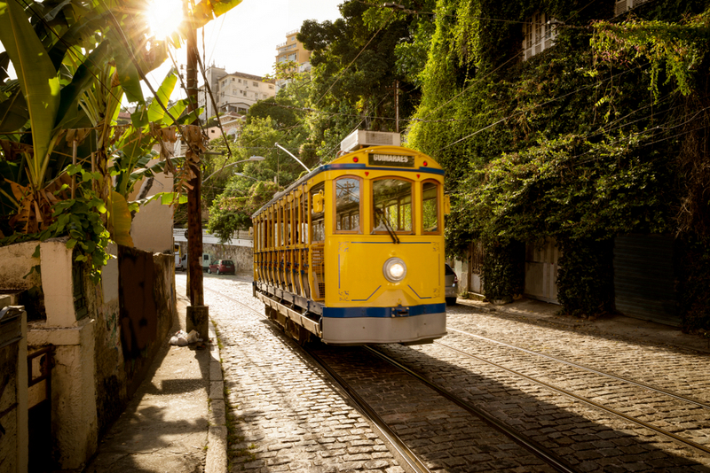 Tramvai galben pe o stradă îngustă cu arbori