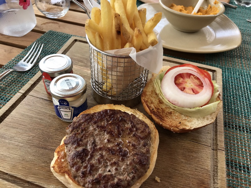 Burger deschis și cartofi prăjiți pe masă