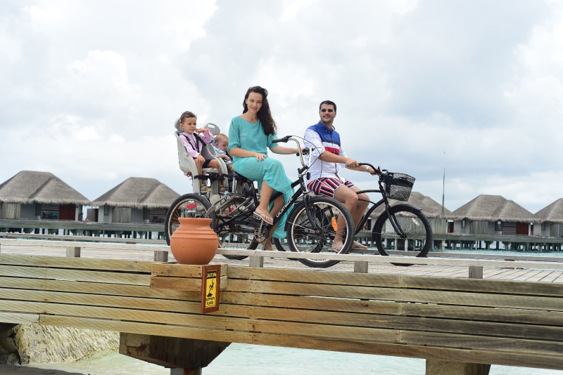 Familie lângă biciclete pe un ponton de lemn