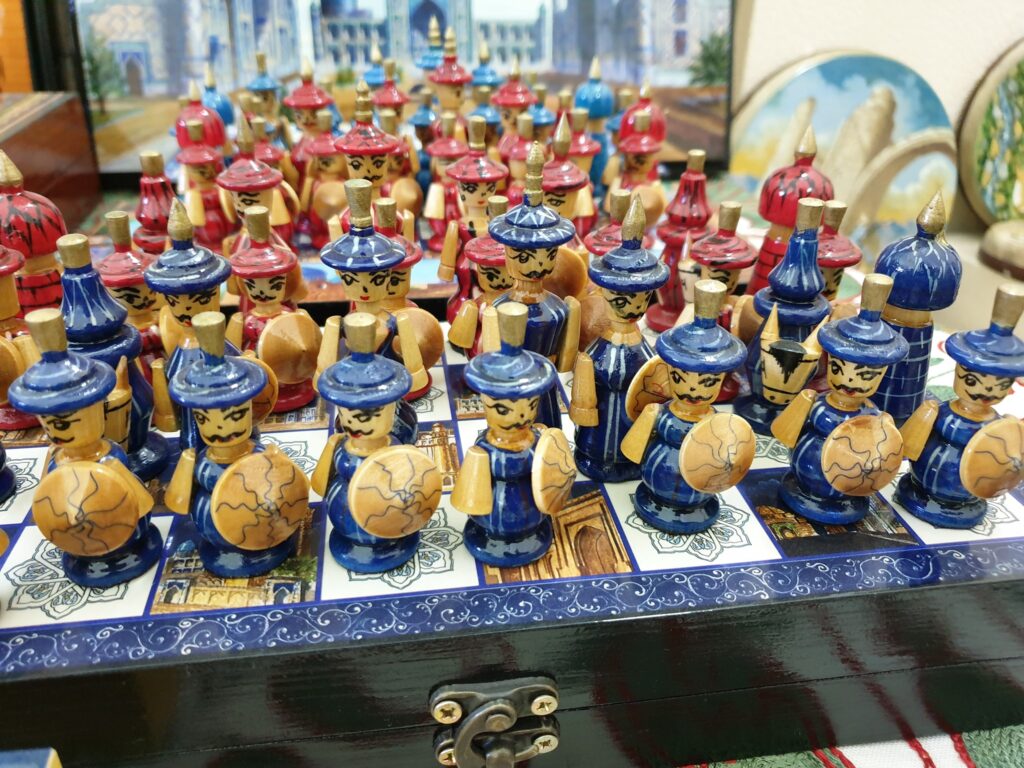 Figurine ceramice colorate aranjate în rânduri pe tarabă