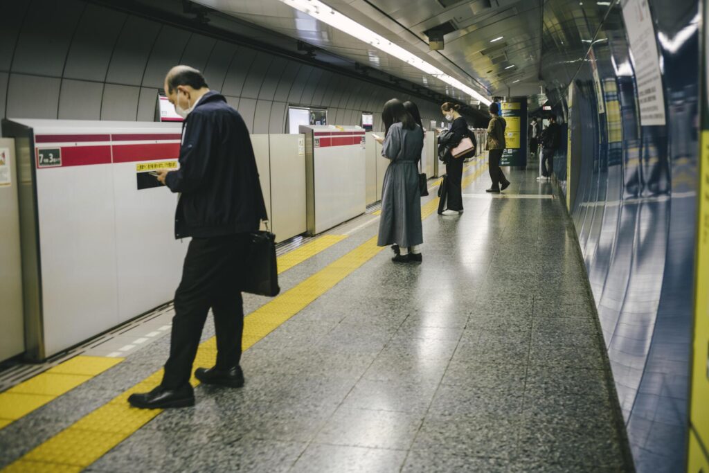 Călători pe peron lângă un tren de metrou