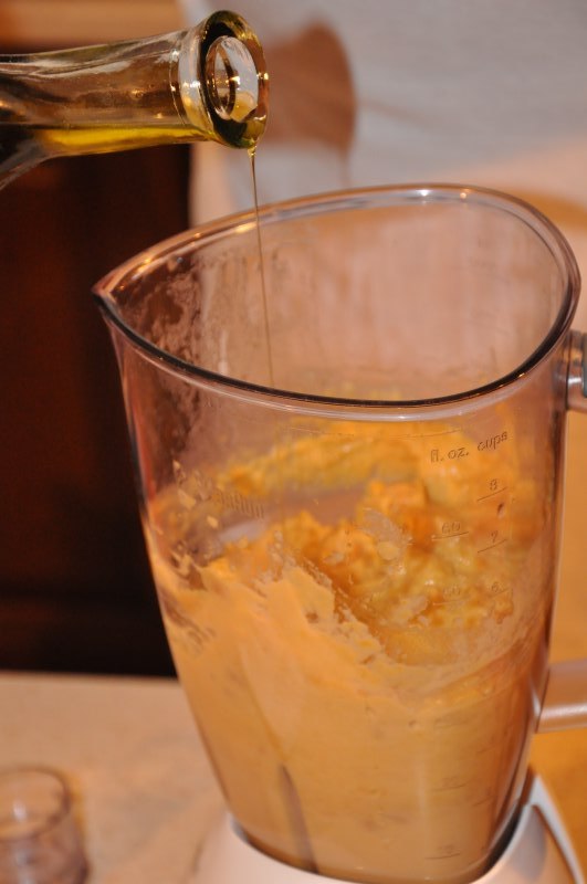 Ulei turnat din sticlă peste pasta din blender